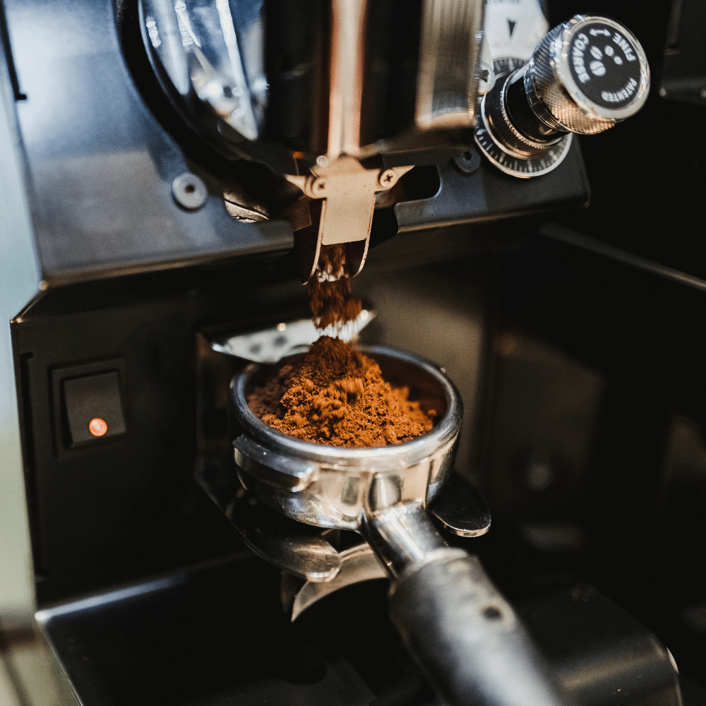 fine ground espresso coffee going into an portafilter