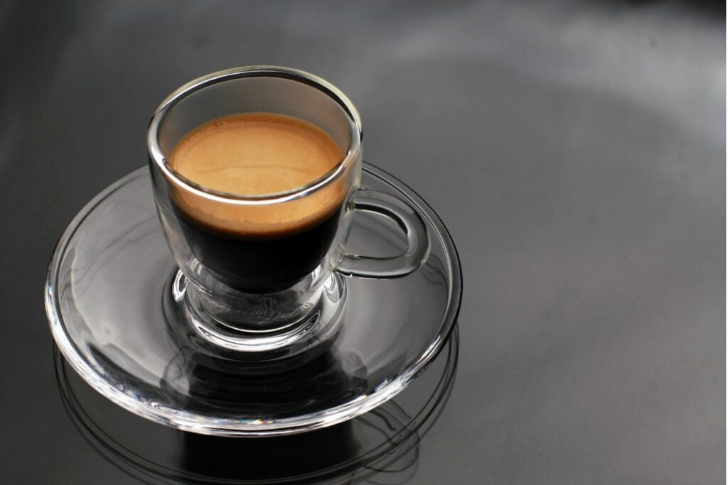 a photo of a glass of espresso coffee