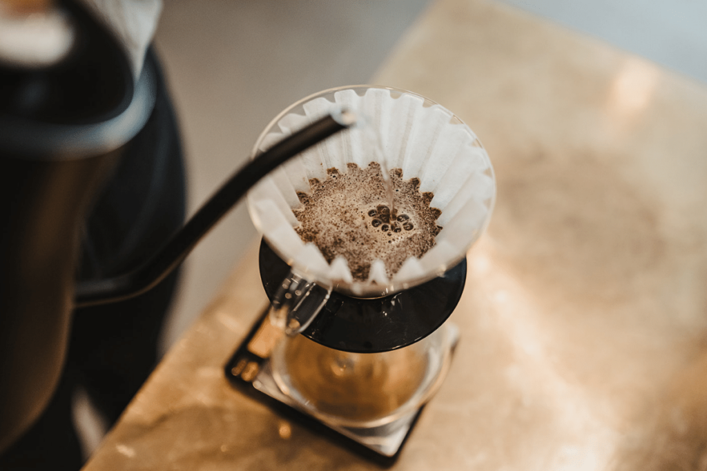 Pouring hot water over a pour over coffee device