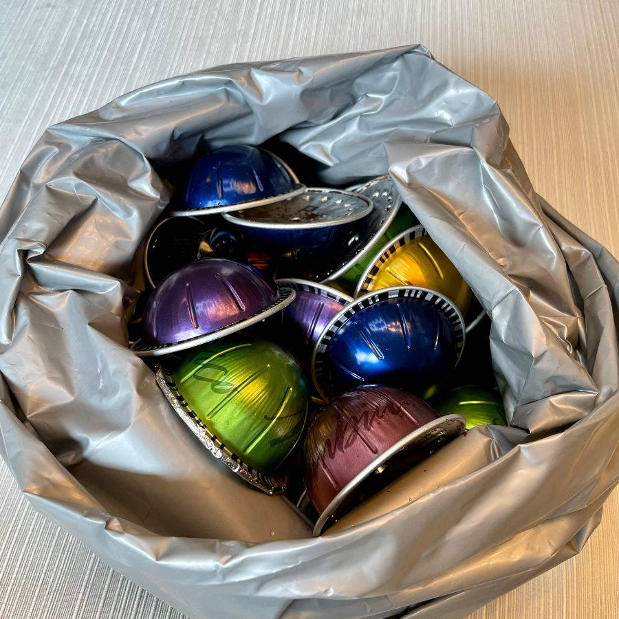  a filled recycling bag of Nespresso pods