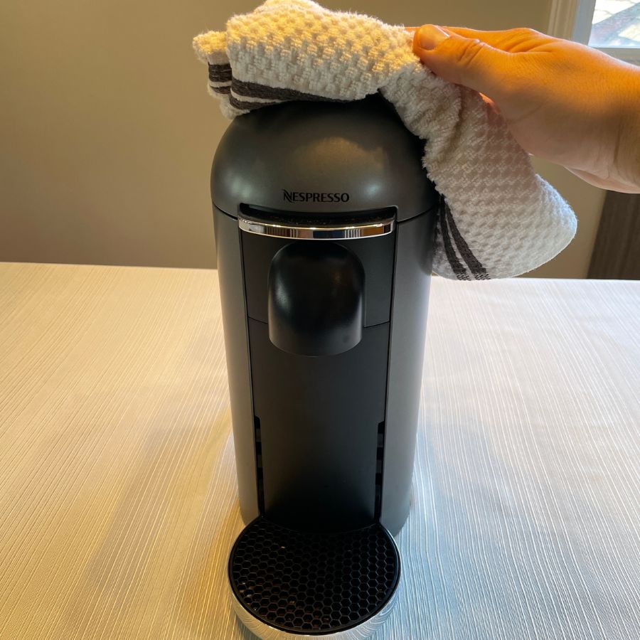 cleaning the nespresso machine with a damp cloth