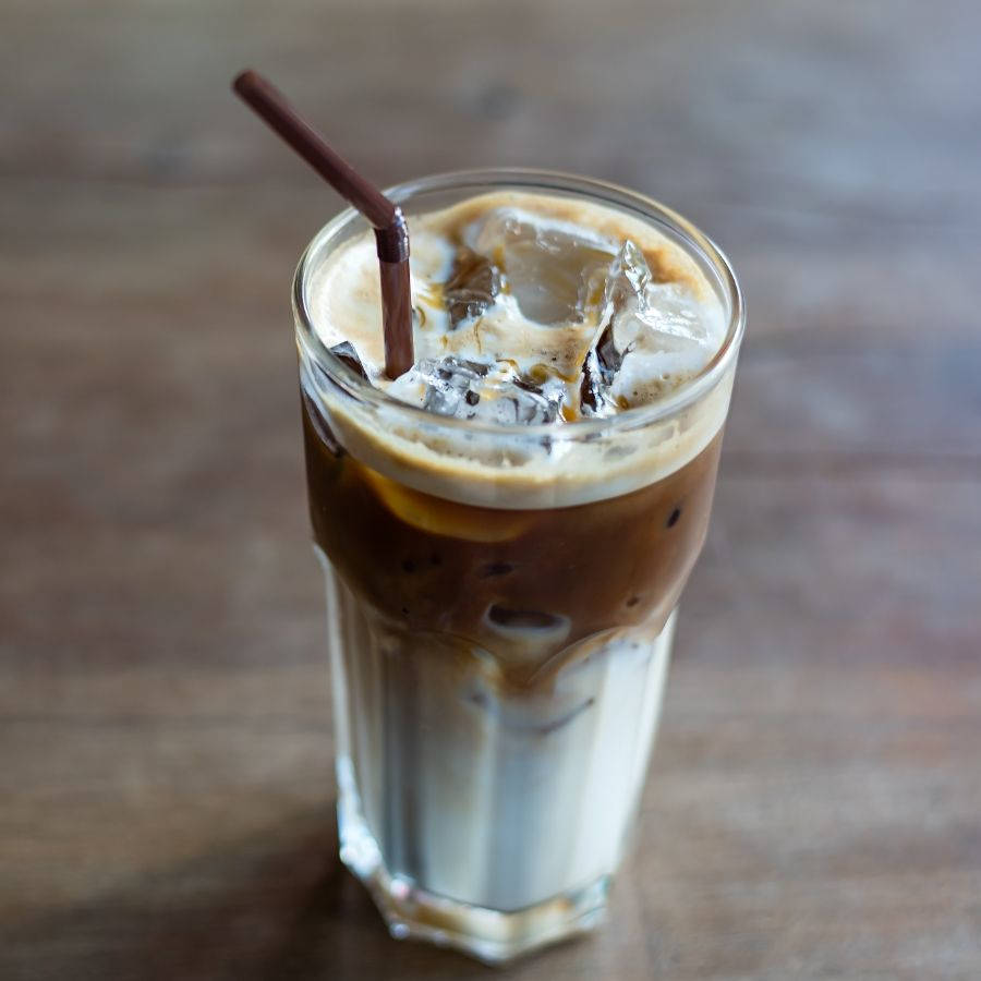 a glass of Starbucks Iced Caramel Macchiato