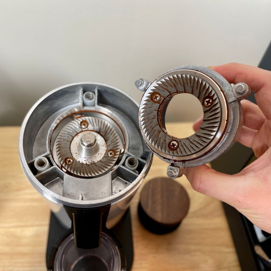 flat burr grinder DF64 with lots of old ground coffee before cleaning, to show the concept of grind retention for burr grinders