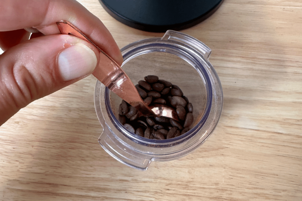 stirring coffee beans with a wet tablespoon to reduce static