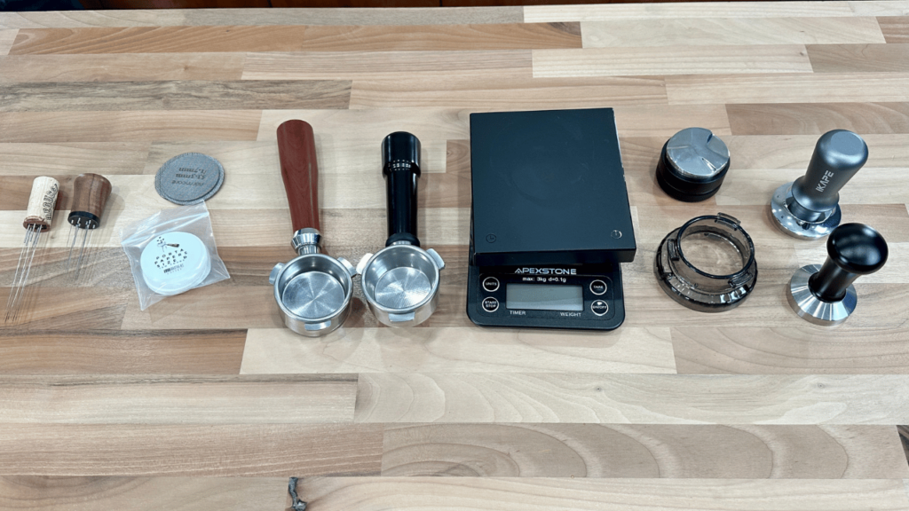 several accessories for a Breville espresso, all laid out on a table