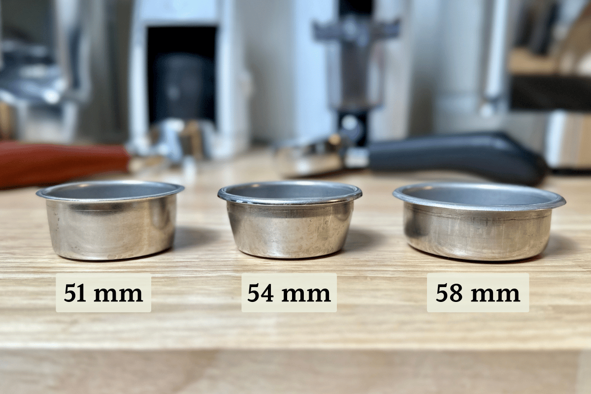 three espresso filter baskets side by side with different sizes, 51mm 54mm and 58mm